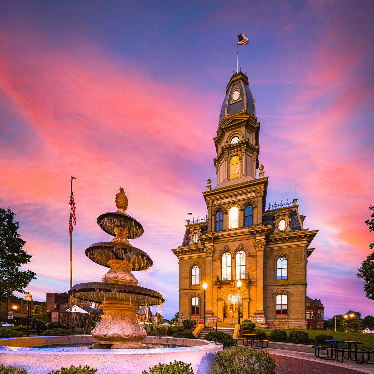 The Logan County Courthouse and pineapple fountain at sunset in Downtown Bellefontaine